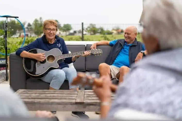 senior woman playing guitar