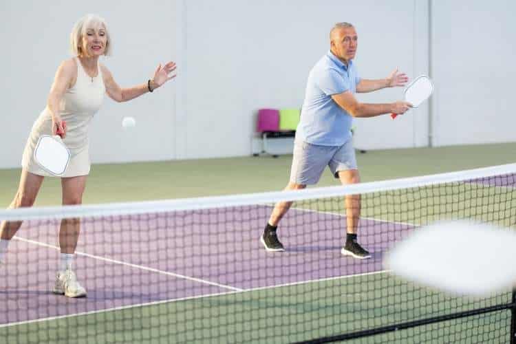 couple play pickle ball
